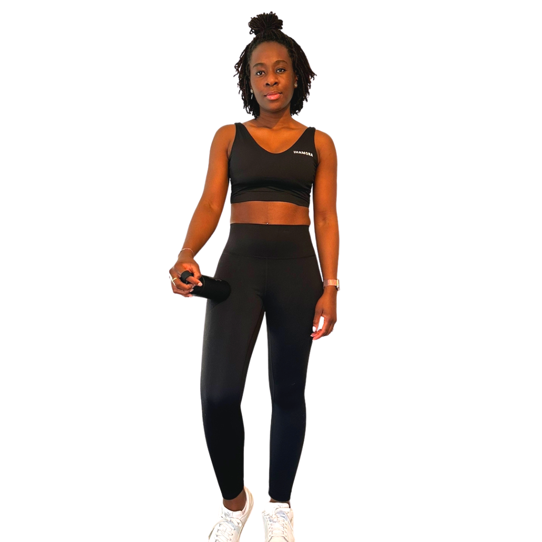 Woman wearing IHAMORA Essential Black High-Waisted Leggings with pockets and supportive waistband.