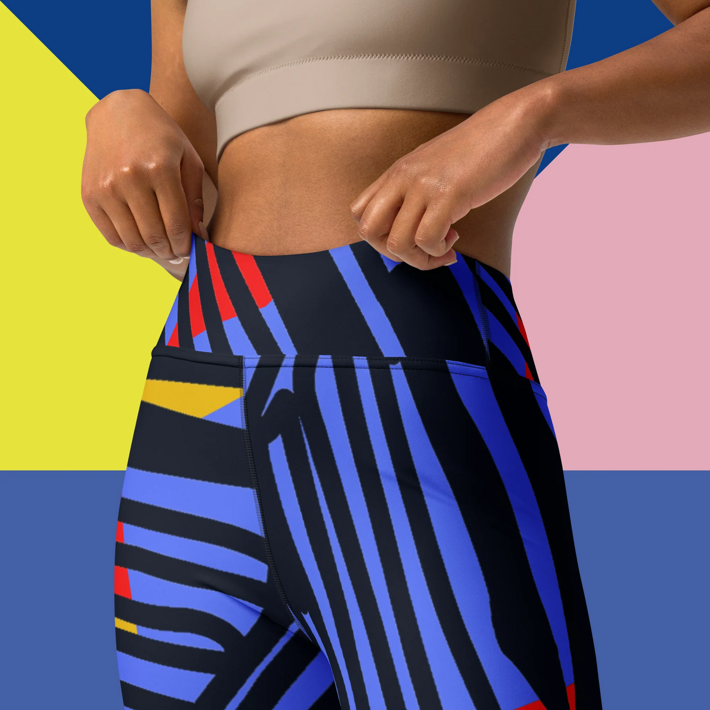 Saber print seamless high-waisted leggings, limited edition IHAMORA activewear XS–4XL. Woman wearing colorful striped leggings on a multicolored geometric background