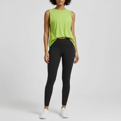 A woman wearing a lime green loose-fit workout vest with dropped armholes, featuring the IHAMORA logo on the back.