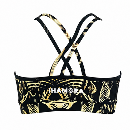 Black and gold patterned sports bra on a white background