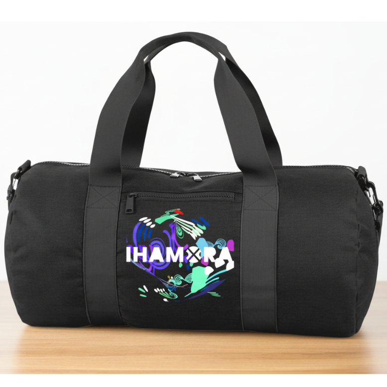 Black duffel bag with colorful design and text on a wooden surface