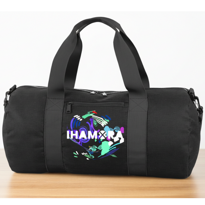 Black duffel bag with colorful design and text on a wooden surface