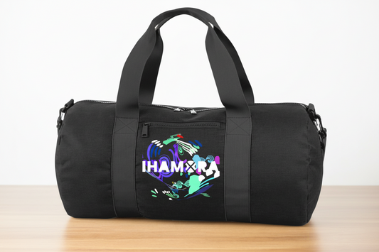 Black duffel bag with colorful design and text on a wooden surface