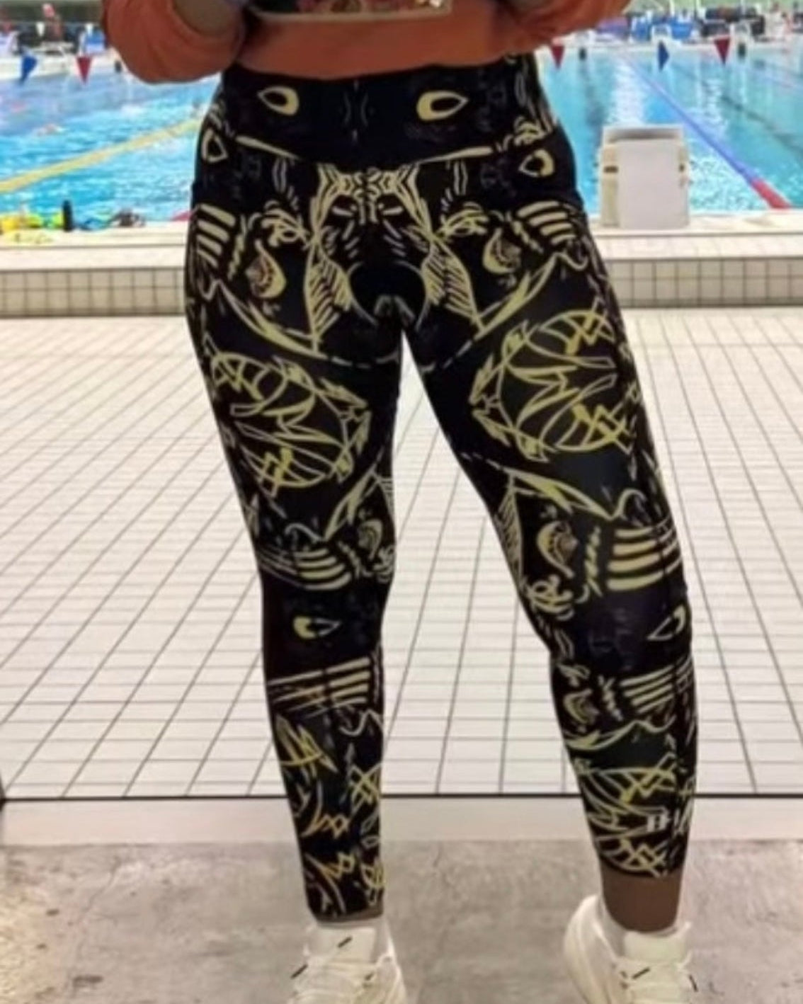 Model wearing IHAMORA Signature The Head Leggings with side pockets and signature face print, seamless high-waisted fit, XS–4XL