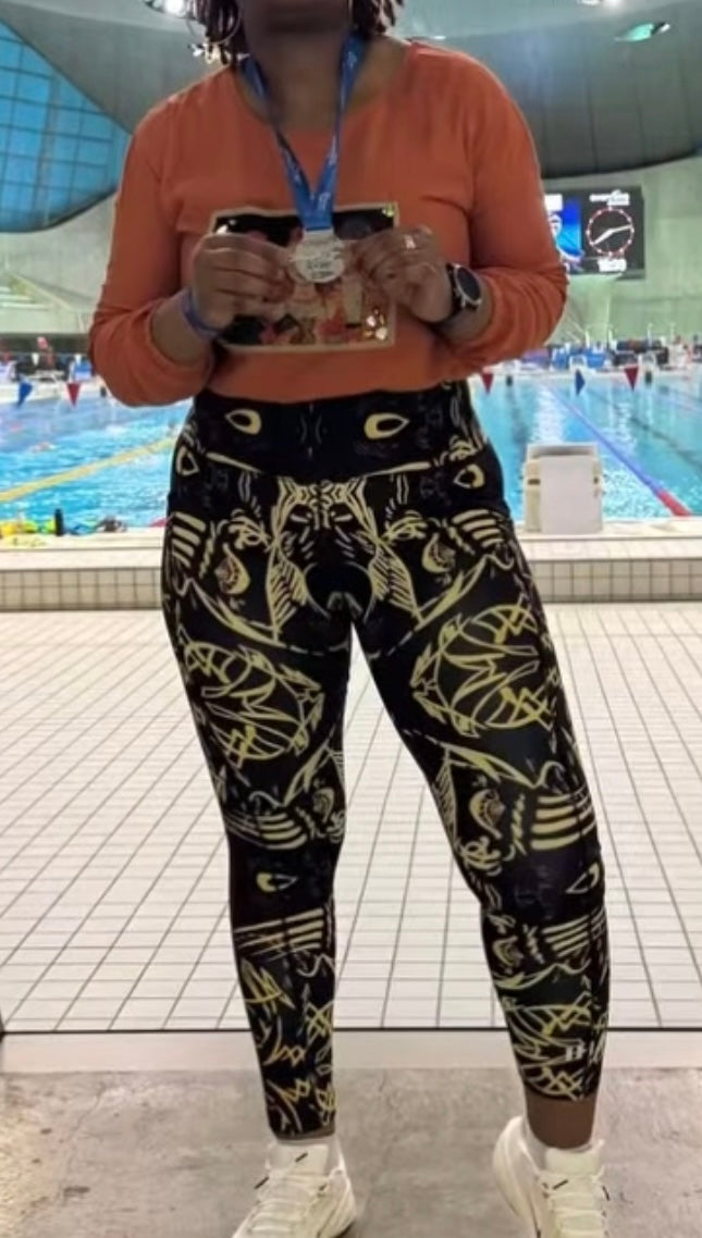 Model wearing IHAMORA Signature The Head Leggings with side pockets and signature face print, seamless high-waisted fit, XS–4XL