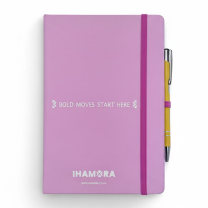 pink notebook with a pen on a light gray background, featuring 'IHAMORA' branding.