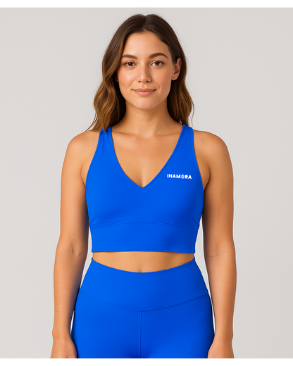 Woman wearing a V NECK blue sports bra with 'IHAMORA' branding on a gray background