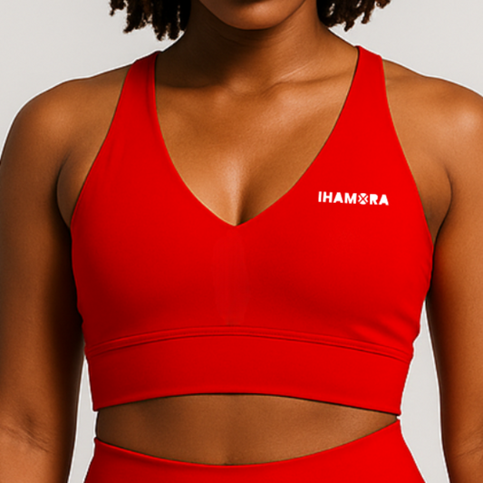 Red sports bra with 'IHAMORA' logo worn by a person on a light gray background