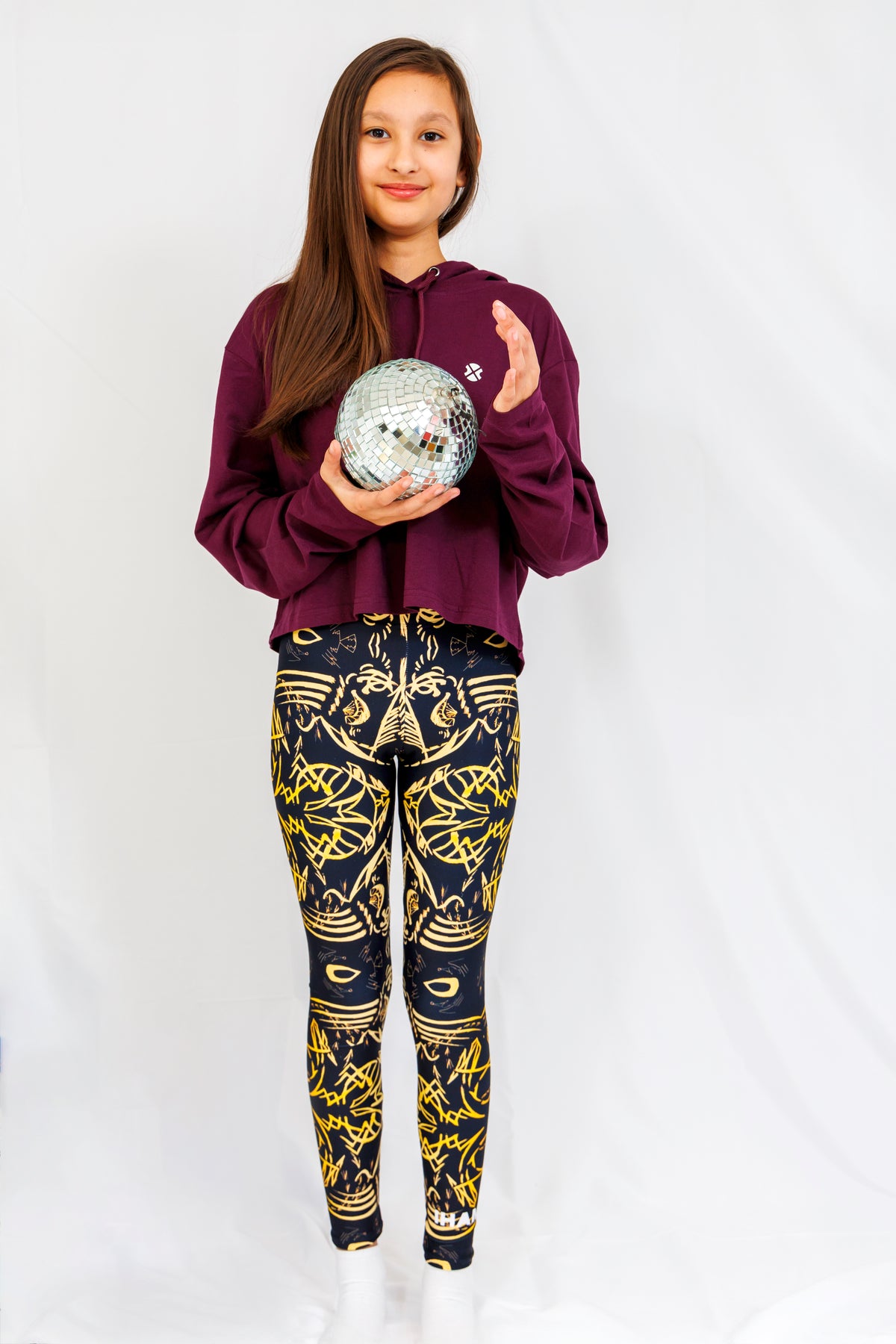 Girl wearing IHAMORA The Head signature print leggings, high-waisted seamless fit.