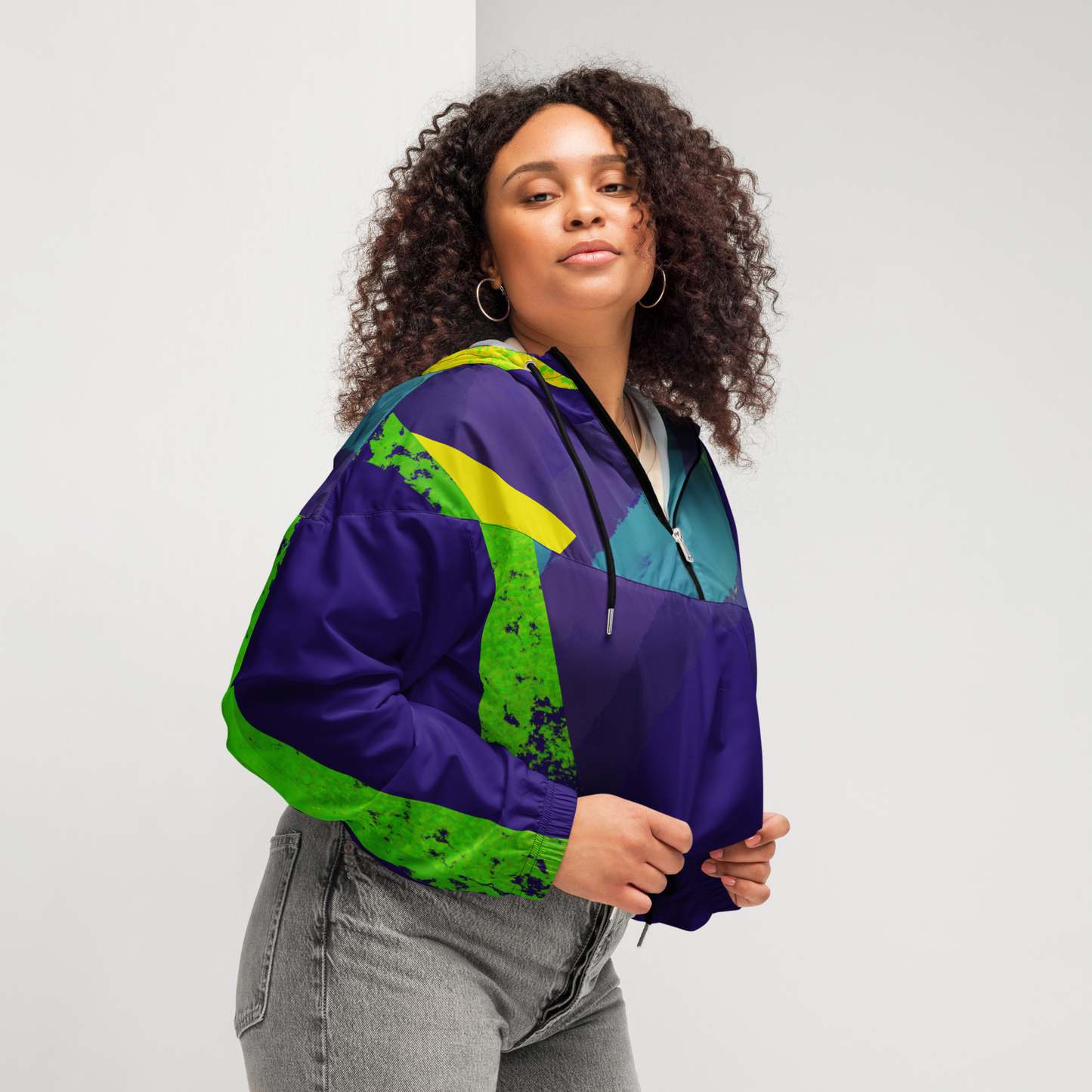 Woman wearing a colorful jacket with a white background